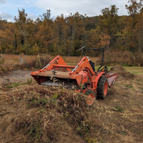 Turning the compost pile with a tractor